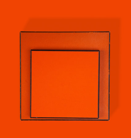 Two orange and brown boxes on orange with long shadowの写真素材