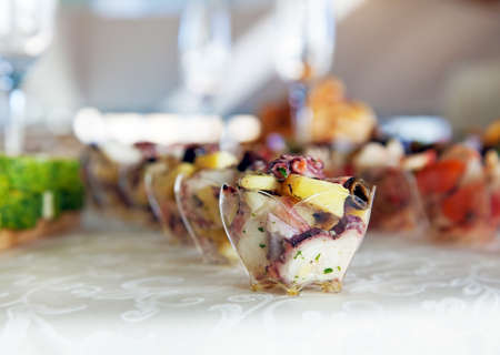 Food for cocktail  on wedding party at hotel (octopus salad in a glass bowl)の写真素材