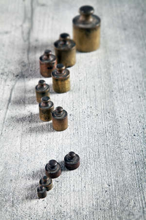 Old metal wights in row with vintage effectの写真素材