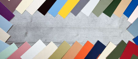 Several multicolored cards on wood backgroundの写真素材
