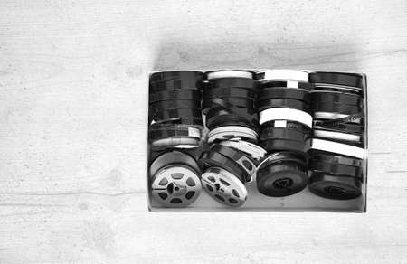 Old movies in a box on wood background (with space for your text or logo)の写真素材