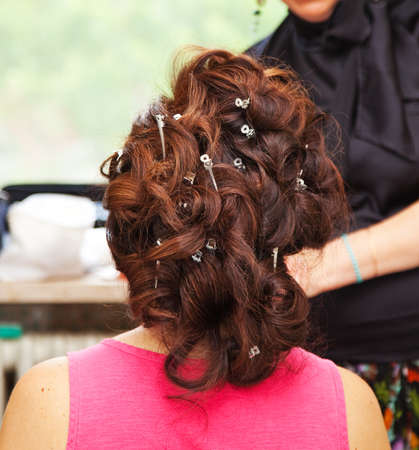 Back of woman with hair curlers and hairpinsの写真素材