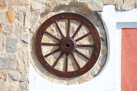 Old wood wheel in a wall.の写真素材