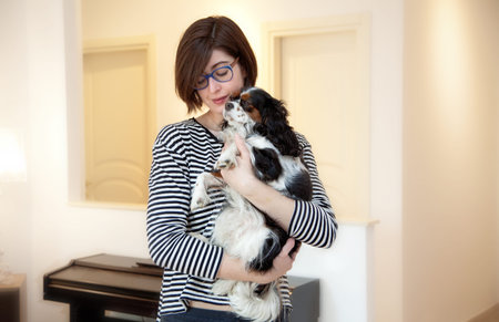 Young woman with Cavalier King Charles Spaniel dog