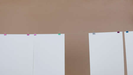 Several sheets of white paper hanging from a threadの写真素材