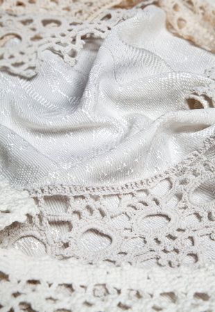 Old Style background: brocade or damask fabric with ancient laces.