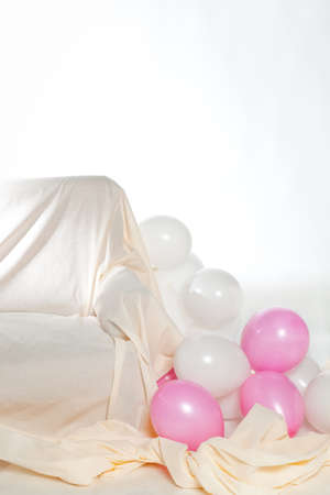Interior with white and pink balloons and sofaの写真素材