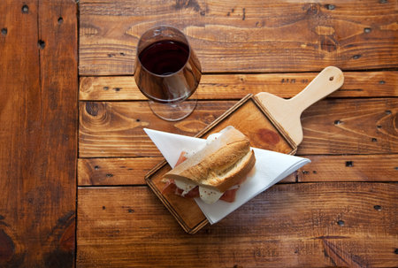 Ham and mozzarella sandwich on a wood chopping board. Selective focus.の写真素材