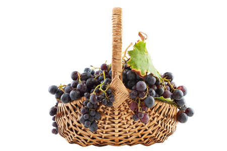 old basket with grapes isolated on white backgroundの写真素材