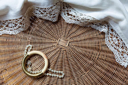 Detail of woven wrinker table with tablecloth, a bracelet and a necklaceの写真素材