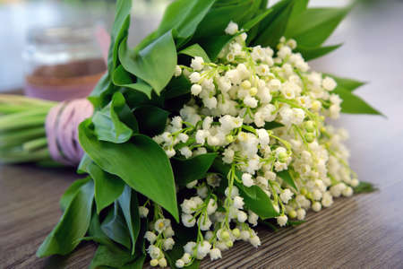 Bouquet of lilies of the valley on wood table.の写真素材