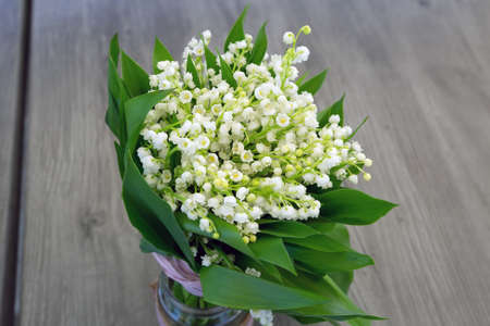 Bouquet of lilies of the valley on wood table.の写真素材