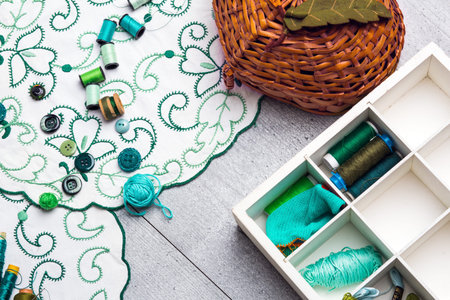 Set of sewing and embroidery supplies on a table: sewing thread, buttons, crochet, embroidered...