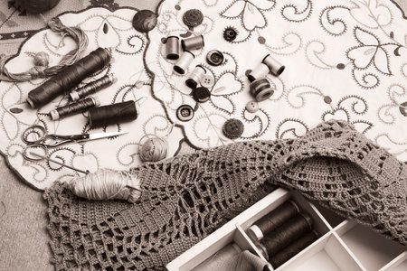 Set of sewing and embroidery supplies on a table: sewing thread, buttons, crochet, embroidered...