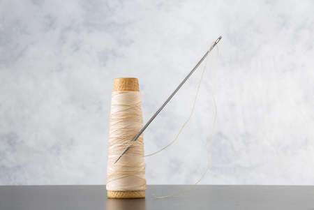 Needle and thread with space for your logo or textの写真素材