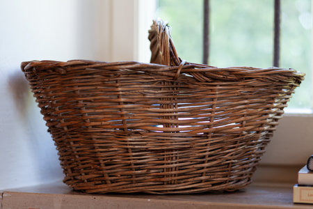 Old empty basket near a window. Concept of country styleの写真素材