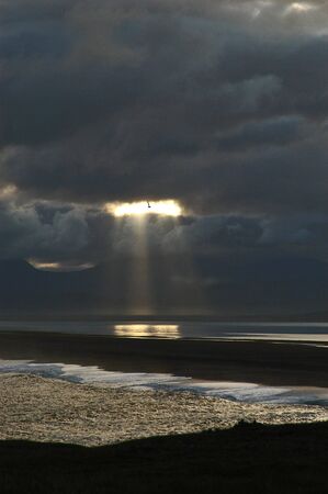 Sun breaks through cloudsの写真素材
