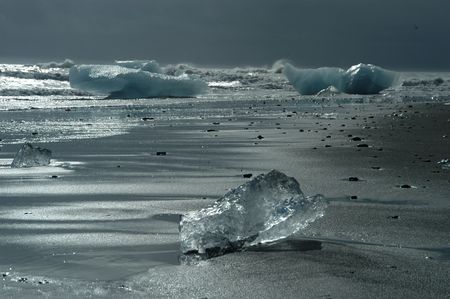 Ice blocks from a glacier on black lava beachの写真素材