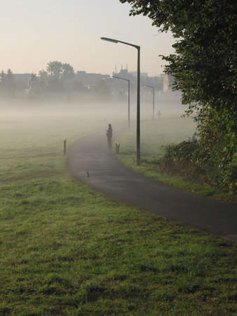Photographer takes photo of morning fogの写真素材