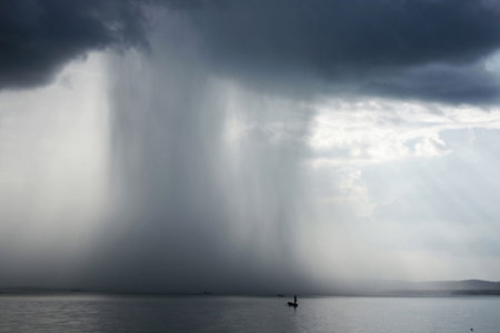 Thunderstorm cloudburst. The effective sky and lakeの写真素材
