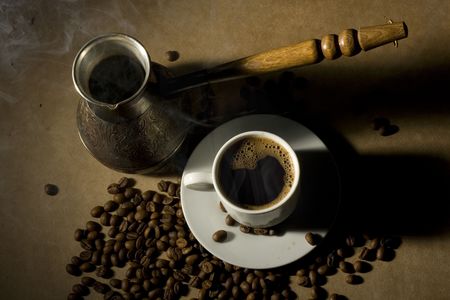 Cup of hot coffee with coffee pot and coffeebeansの写真素材