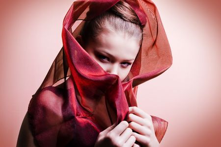 beautiful girl enveloped  in red headscarf. Fashion photoの写真素材