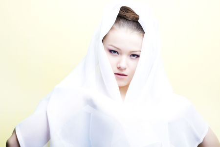 beautiful girl enveloped  in white headscarf. Fashion photoの写真素材