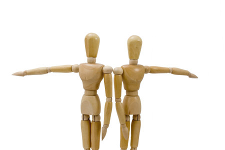 Two wooden figures pointing in opposite directionsの写真素材