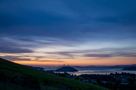 Morning Silhouette of San Francisco Skyline showing reflection of the early light on the San Francisco Bay panorama of brilliant morning colors outlining the architecture and design of the skylineの写真素材