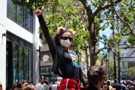 San Francisco, CA, USA - June 22, 2022: Pride Parade: Photo shows attendee waving and watching the...
