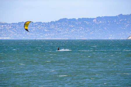 Kite Surfing in California against backdrop of landmark blue waterの写真素材