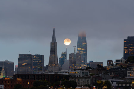 San Francisco skyline with July 12 2022 supermoon next to famous landmark buildings