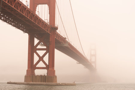 Golden Gate Bridge on a misty foggy day as seen from beneath it on the San Francisco side.の写真素材