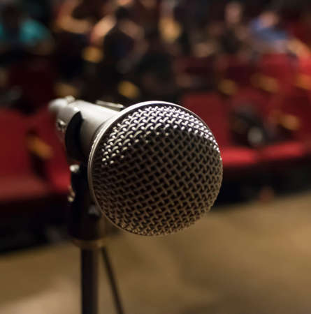 Close up of a microphone against a theater backgroundの写真素材
