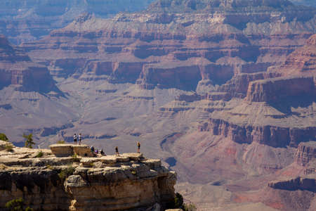 Panorama photo of the Grand Canyon with tourists enjoying the viewの写真素材