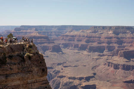 Panorama photo of the Grand Canyon with tourists taking picturesの写真素材
