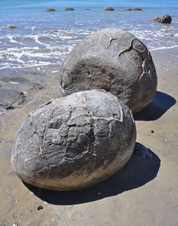 Moeraki Boulders are perfectly spherical rocks on the beach at Moeraki, north of Dunedin, near Oamaru. Up to 13 feet round Maori believe they were food baskets on the original Maori canoeの写真素材