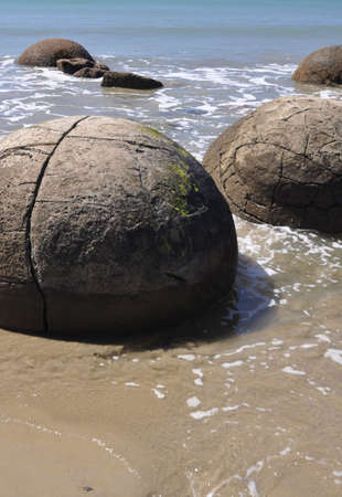 Moeraki Boulders are perfectly spherical rocks on the beach at Moeraki, north of Dunedin, near Oamaru. Up to 13 feet round Maori believe they were food baskets on the original Maori canoeの写真素材