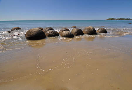 Moeraki Boulders are perfectly spherical rocks on the beach at Moeraki, north of Dunedin, near Oamaru. Up to 13 feet round Maori believe they were food baskets on the original Maori canoeの写真素材