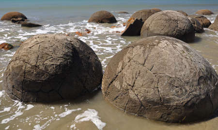 Moeraki Boulders are perfectly spherical rocks on the beach at Moeraki, near Oamaru. Up to 13 feet round Maori believe they were canoe food baskets.の写真素材