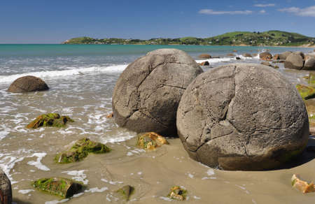 Moeraki Boulders are perfectly spherical rocks on the beach at Moeraki, near Oamaru. Up to 13 feet round Maori believe they were canoe food baskets.の写真素材