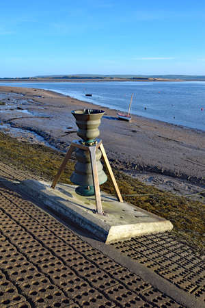Appledore, Devon, England, UK - 5th April 2017. The  Time and Tide Bell was the first if 5 brass installations by Marcus Vergette around the coast of the UK. The pitch of the bell varies as the tide risesのeditorial素材