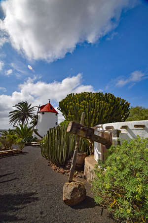 Tiagua, Lanzarote, Spain, - 28 February 2017. Traditional Spanish windmill at Museo Agricola  El Patio, in the village of Tiagua on the island of  Lanzarote, old wine press in foregroundのeditorial素材