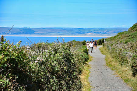Westward Ho!, North Devon, England 5th July 2017 - Looking East towards the coastal town of Westward Ho! (about half a mile ) on the Southwest Coast  National Trail Path.のeditorial素材