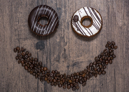 Smiling face made from coffee beans and donut