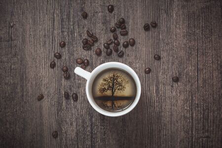 Bautiful picture inside the cup of coffee on the table with a coffee beansの写真素材