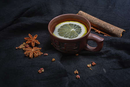 Lemon tea and spices on the black backgroundの写真素材