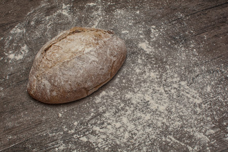 wheat flour with a fresh  hot bread  on the table