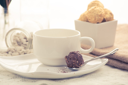 Italian chocolate sweets at the morning with cup of coffeeの写真素材