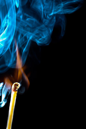 Ignition of match with smoke, isolated on black background